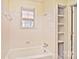 Clean bathroom with white tiled walls, a bathtub, and built-in shelving at 936 23Rd Ne Ave, Hickory, NC 28601