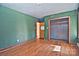 Simple bedroom with wood flooring, closet, and dark green walls at 936 23Rd Ne Ave, Hickory, NC 28601