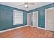 Simple bedroom with wood flooring and teal walls at 936 23Rd Ne Ave, Hickory, NC 28601