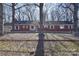 Brick ranch house with mature trees and fenced yard at 936 23Rd Ne Ave, Hickory, NC 28601