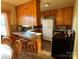 Galley kitchen with wood cabinets and tiled floor at 9915 Washam Potts Rd, Cornelius, NC 28031