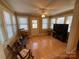 Sunroom with hardwood floors, rocking chairs and large windows at 9915 Washam Potts Rd, Cornelius, NC 28031