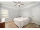 Bright bedroom with light wood floors, featuring a comfortable bed and window coverings at 1002 Wayland Ct, Indian Trail, NC 28079