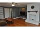 Living room with hardwood floors, white fireplace and built-in shelving at 109 Shamrock Dr, Chester, SC 29706