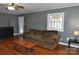 Living room with hardwood floors, ceiling fan and brown sofa at 109 Shamrock Dr, Chester, SC 29706