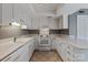 Galley style kitchen with white cabinets and built-in appliances at 11108 Sevilla Ct, Charlotte, NC 28226