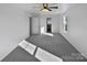 Bright bedroom with grey carpeting and ceiling fan at 113 Boiling Brook Dr, Statesville, NC 28625