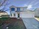 Two-story house with attached garage and landscaped yard at 113 Boiling Brook Dr, Statesville, NC 28625