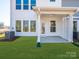 Backyard with patio, green grass and access to the home's interior at 119 Quartz Hill Way, Waxhaw, NC 28173