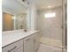 Bathroom featuring a white sink, cabinets, a white countertop, and a glass enclosed shower with white marble patterned tiles at 119 Quartz Hill Way, Waxhaw, NC 28173