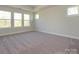 Spacious carpeted bedroom with tray ceiling and many windows at 119 Quartz Hill Way, Waxhaw, NC 28173