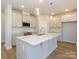Bright kitchen featuring a large center island, pendant lighting, and stainless steel appliances at 119 Quartz Hill Way, Waxhaw, NC 28173