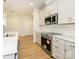 Stylish kitchen with stainless steel appliances, ample cabinet space, and modern countertops at 119 Quartz Hill Way, Waxhaw, NC 28173
