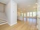 Open-concept living space with abundant natural light, wood floors, and modern staircase at 119 Quartz Hill Way, Waxhaw, NC 28173