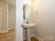 Cozy powder room features a stylish pedestal sink and modern fixtures at 119 Quartz Hill Way, Waxhaw, NC 28173