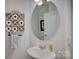 Powder room with pedestal sink and oval mirror at 1224 Regions Blvd, Fort Mill, SC 29707