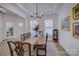 Elegant dining room with hardwood floors, chandelier, and large windows at 1224 Regions Blvd, Fort Mill, SC 29707