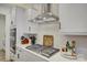 Modern kitchen with gas cooktop, stainless steel range hood, and white cabinets at 1224 Regions Blvd, Fort Mill, SC 29707