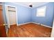 Blue bedroom with hardwood floors and closet at 1308 Mckay Rd, Newton, NC 28658