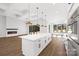 Modern kitchen with white cabinets, a large island, and stainless steel appliances at 13306 Graymist Dr, Charlotte, NC 28215