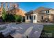 Charming back patio with tiled flooring, exterior dining, and lovely landscaping at 15618 Frohock Pl, Charlotte, NC 28277