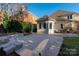 A beautiful backyard featuring a stone patio, lush greenery and a well-maintained lawn at 15618 Frohock Pl, Charlotte, NC 28277