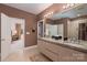 Stylish bathroom featuring double sink vanity with granite countertop and modern lighting fixtures at 15618 Frohock Pl, Charlotte, NC 28277