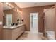 Bathroom featuring double sinks, granite countertops, updated lighting, and a walk-in closet at 15618 Frohock Pl, Charlotte, NC 28277