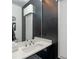 Modern bathroom featuring a sleek black vanity, a stylish mirror, and a contemporary faucet at 15618 Frohock Pl, Charlotte, NC 28277