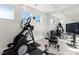 Bright exercise room with modern fitness equipment and a large mirror for training at 15618 Frohock Pl, Charlotte, NC 28277