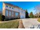 Beautiful traditional home featuring a long driveway, two-car garage, and stone facade at 15618 Frohock Pl, Charlotte, NC 28277