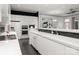 Modern kitchen with white cabinetry, black backsplash, and stainless steel appliances at 15618 Frohock Pl, Charlotte, NC 28277