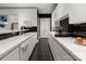 Sleek kitchen with black tile floors, white cabinets and modern appliances at 15618 Frohock Pl, Charlotte, NC 28277