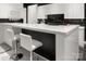 Kitchen island with white countertops, stylish barstools, and sleek cabinetry at 15618 Frohock Pl, Charlotte, NC 28277