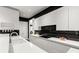 Bright kitchen featuring white cabinets, black accents, and modern design elements at 15618 Frohock Pl, Charlotte, NC 28277
