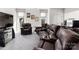 Spacious living room with plush leather seating and a large entertainment center at 15618 Frohock Pl, Charlotte, NC 28277