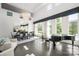 Bright and modern living room with piano, dining table and chairs, and large windows for natural light at 15618 Frohock Pl, Charlotte, NC 28277