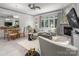 Inviting living room featuring a fireplace, plush seating, dining area, and large windows with a serene view at 15618 Frohock Pl, Charlotte, NC 28277