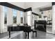 Bright living room with a piano and fireplace, bathed in natural light from large windows and tall ceilings at 15618 Frohock Pl, Charlotte, NC 28277