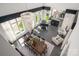 Aerial perspective of the living space featuring a dining area, piano, seating, and an elegant chandelier at 15618 Frohock Pl, Charlotte, NC 28277