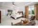 Bright and airy main bedroom with elegant decor, a tray ceiling, and cozy seating area at 15618 Frohock Pl, Charlotte, NC 28277