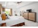 Comfortable main bedroom with a king-size bed, a seating area, and a modern dresser at 15618 Frohock Pl, Charlotte, NC 28277