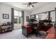 Comfortable home office with a large window and multiple computer monitors on a red and black desk at 15618 Frohock Pl, Charlotte, NC 28277