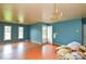 Light brown hardwood floors and blue walls in the living room at 1726 Umstead St, Charlotte, NC 28205