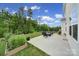 Expansive backyard with a concrete patio, lush green grass, and mature trees at 18022 Stark Way, Charlotte, NC 28278