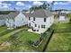 The backyard features a patio, garden beds, a lush green lawn, and black fence at 18022 Stark Way, Charlotte, NC 28278