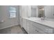 Bright bathroom with double vanity, granite countertops, and tiled floor at 18022 Stark Way, Charlotte, NC 28278