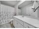 Well-lit bathroom features white vanity, a large mirror, and a shower with a decorative curtain at 18022 Stark Way, Charlotte, NC 28278