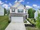 Charming two-story home boasts a stone facade and landscaped front yard at 18022 Stark Way, Charlotte, NC 28278