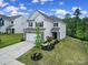 Charming two-story home with a well-manicured lawn, long driveway, and inviting front porch at 18022 Stark Way, Charlotte, NC 28278